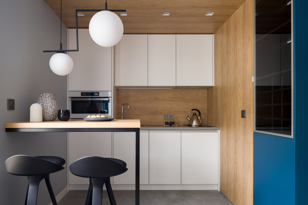 amenajare bucatarie mica de bloc mobilier minimalist masa scaune de bar blat de lucru finisaj placaj lemn fronturi albe stil industrial