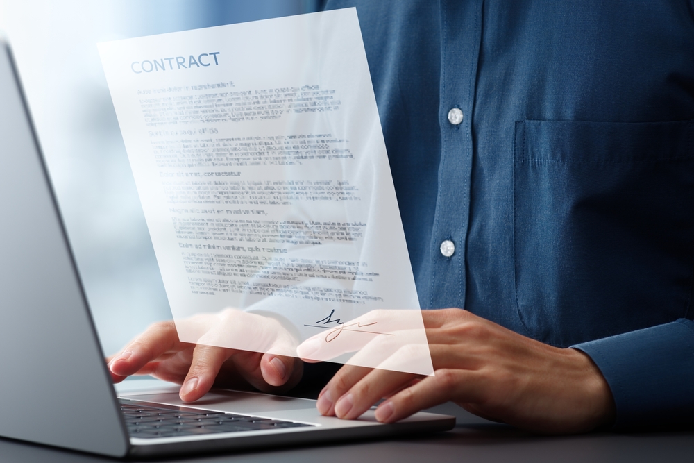 schimbare titular contract energie făcută de bărbat la laptop cu proiect contract in față